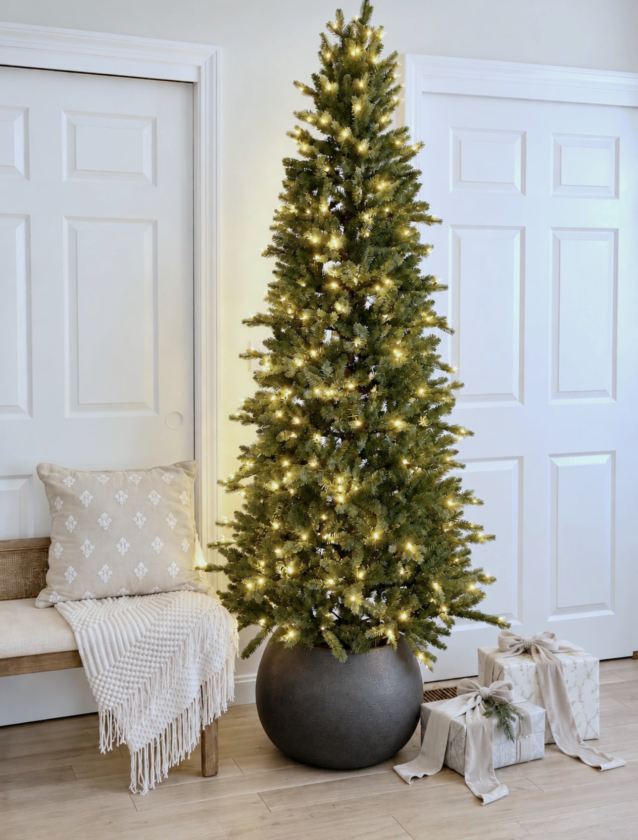 Round black planter with a pencil Christmas tree in it.