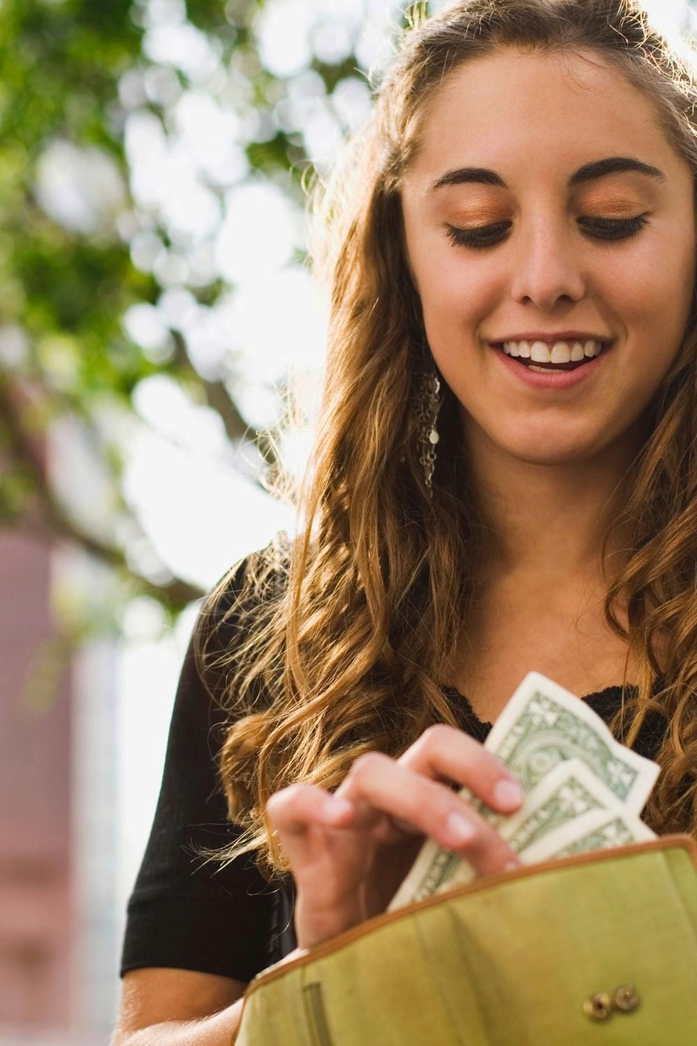 Woman with a wallet with cash. 