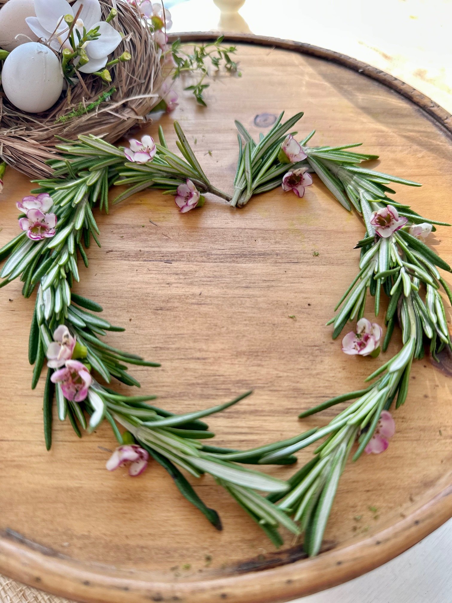 A heart made from wax flower and rosemary.