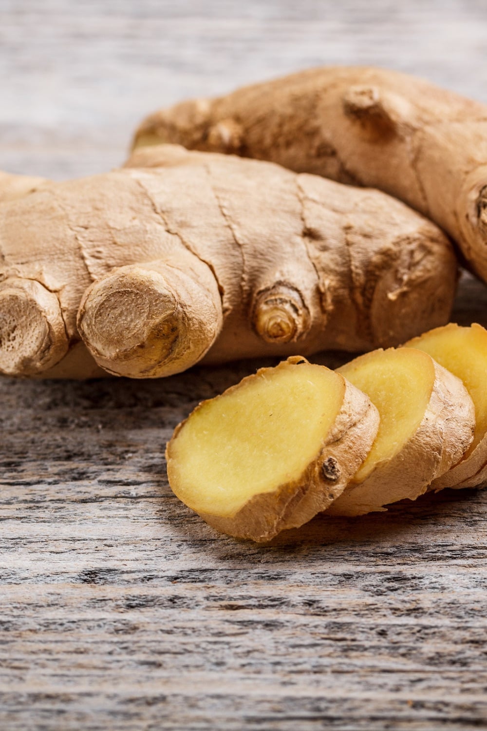 Fresh ginger root laying on a board.