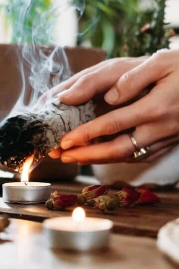 Herbs for protection. Smudging herbs over a flame.