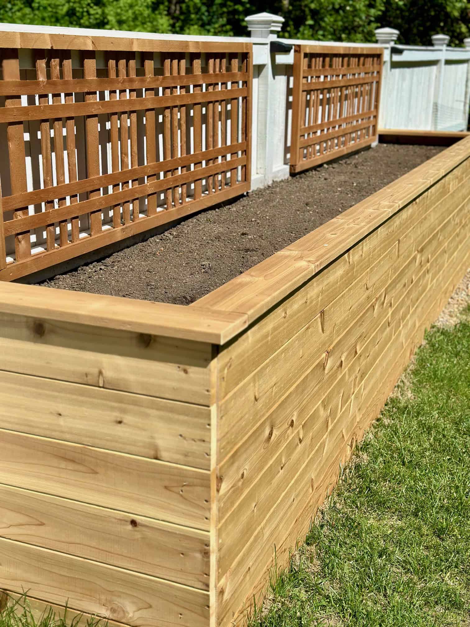 An empty raised bed with only soil.