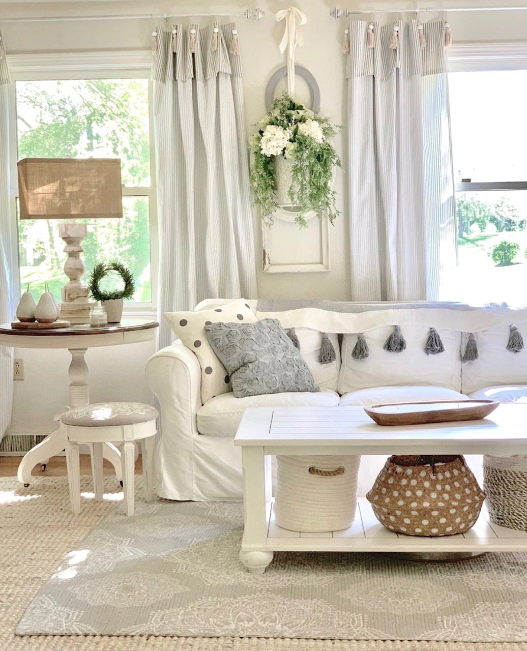 Touches of green and/or black added to a cozy white living room.