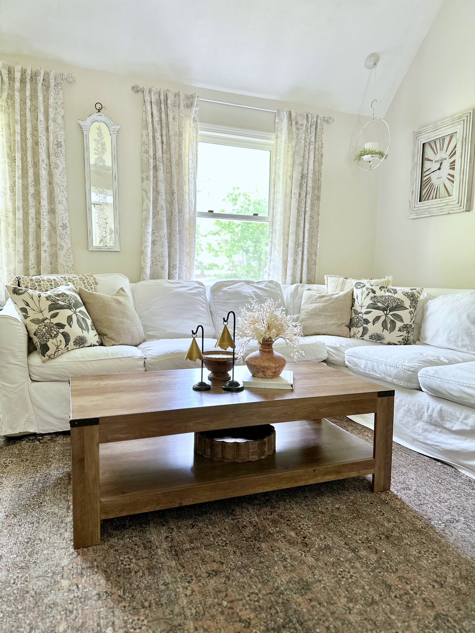 A full view of our white sectional with clusters of pillows in each corner. 