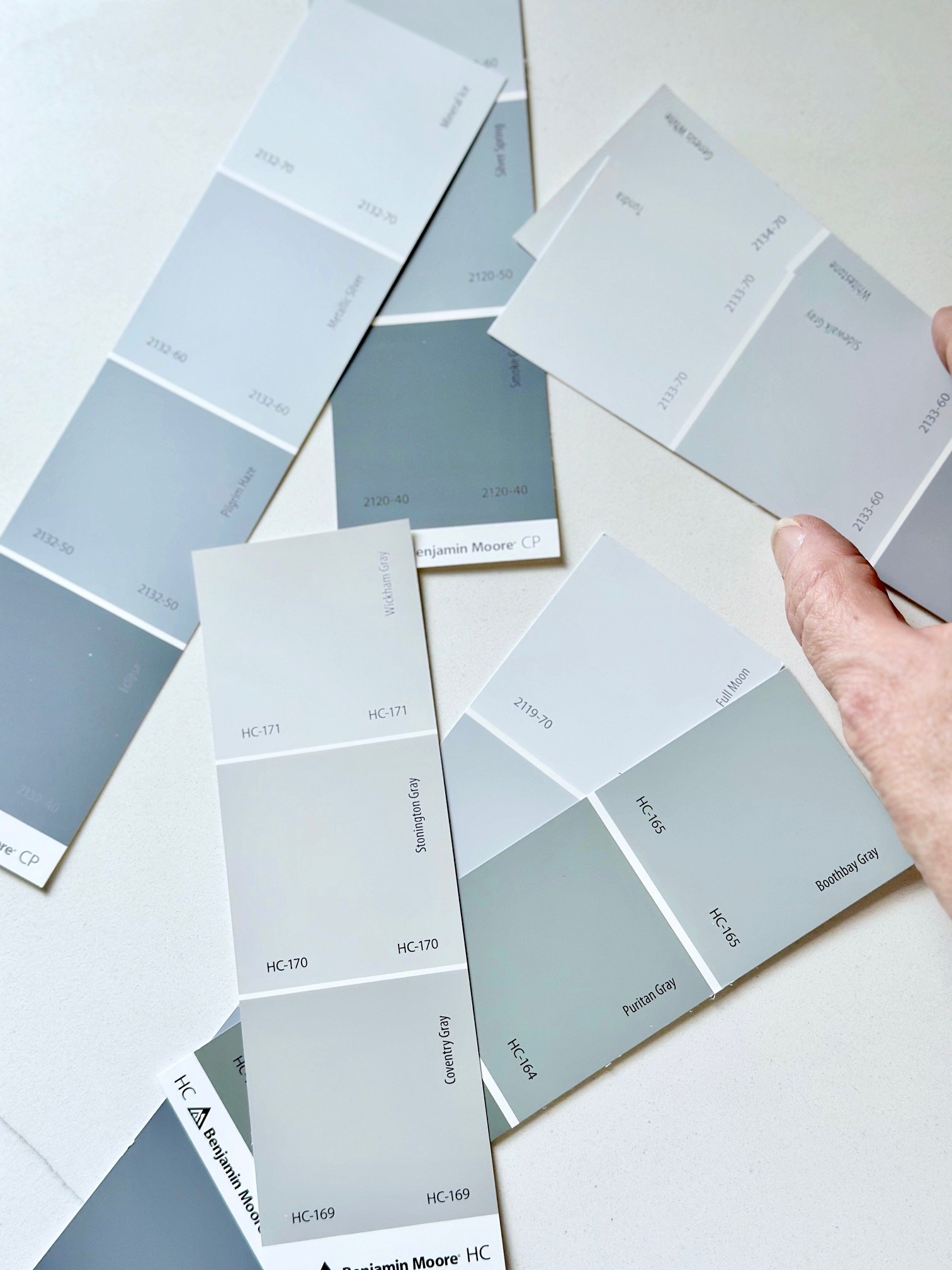 An array of paint chip samples scattered on a table.