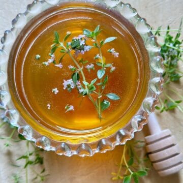 Honey with beautiful thyme blossoms floating in it.