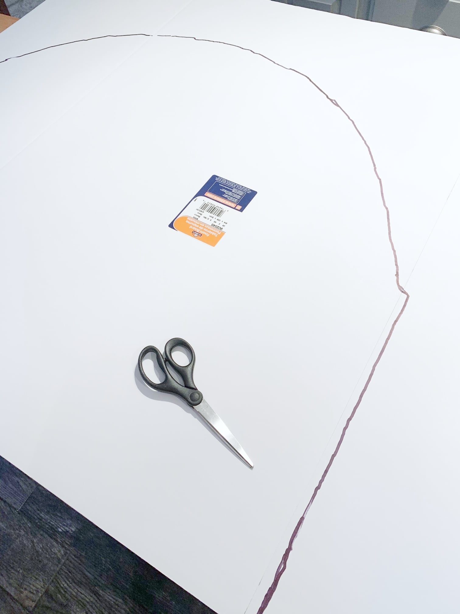 Tracing the opening of the fireplace onto the foam board with a sharpie.