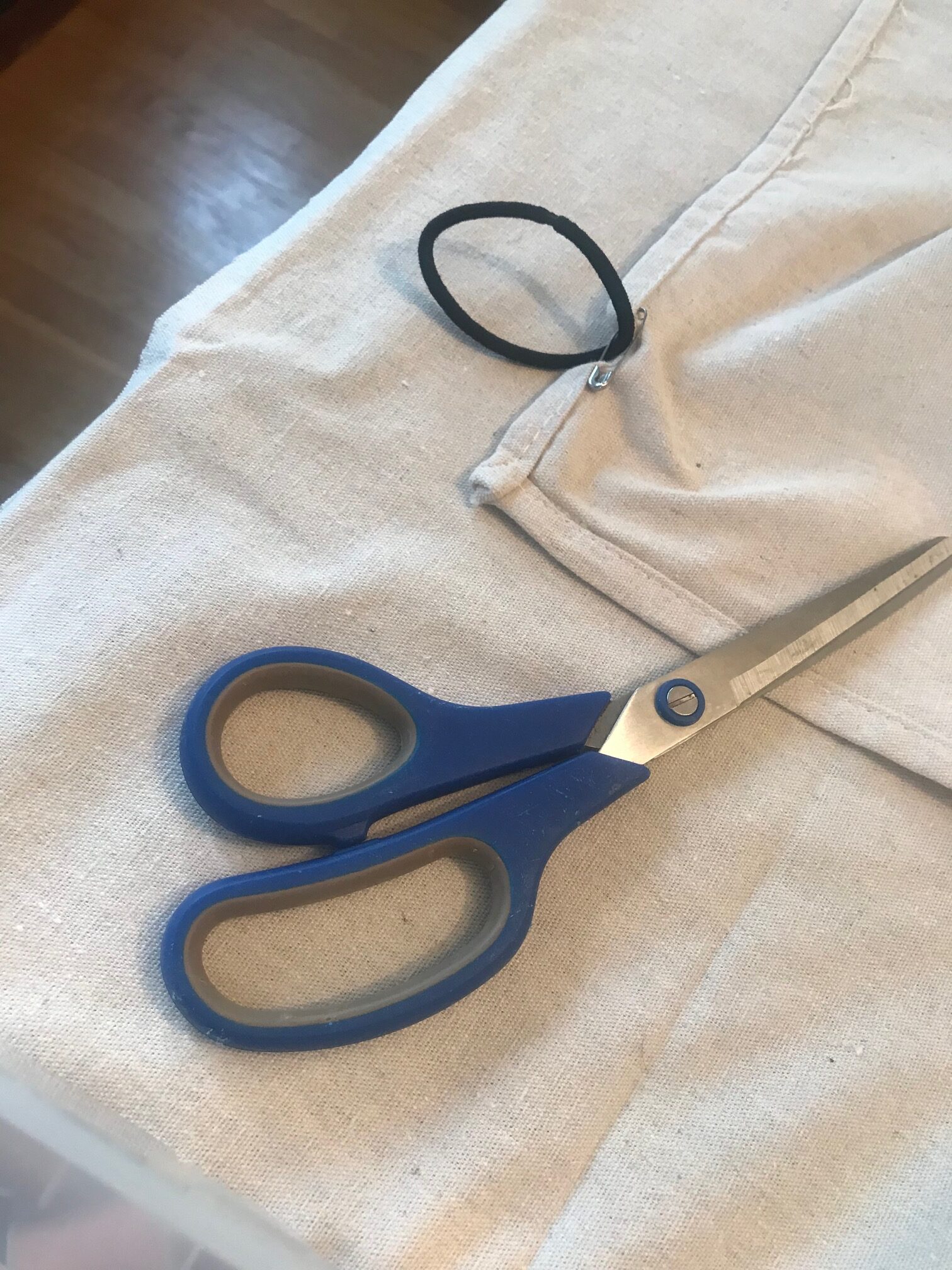 Hair tie pinned to the back of the drop cloth curtain.