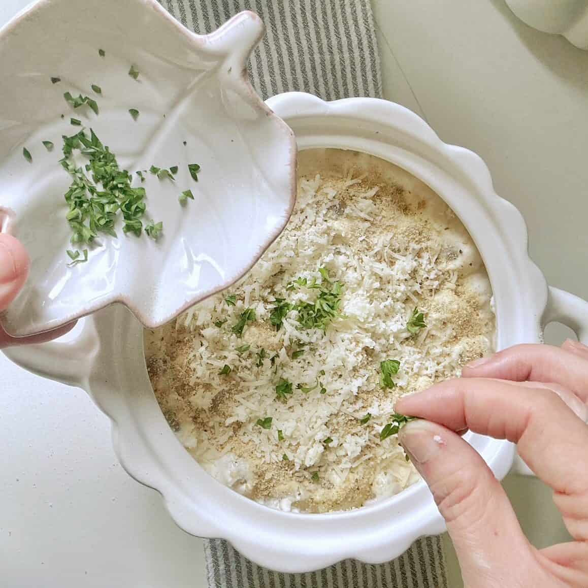 Putting the toppings on the casserole.