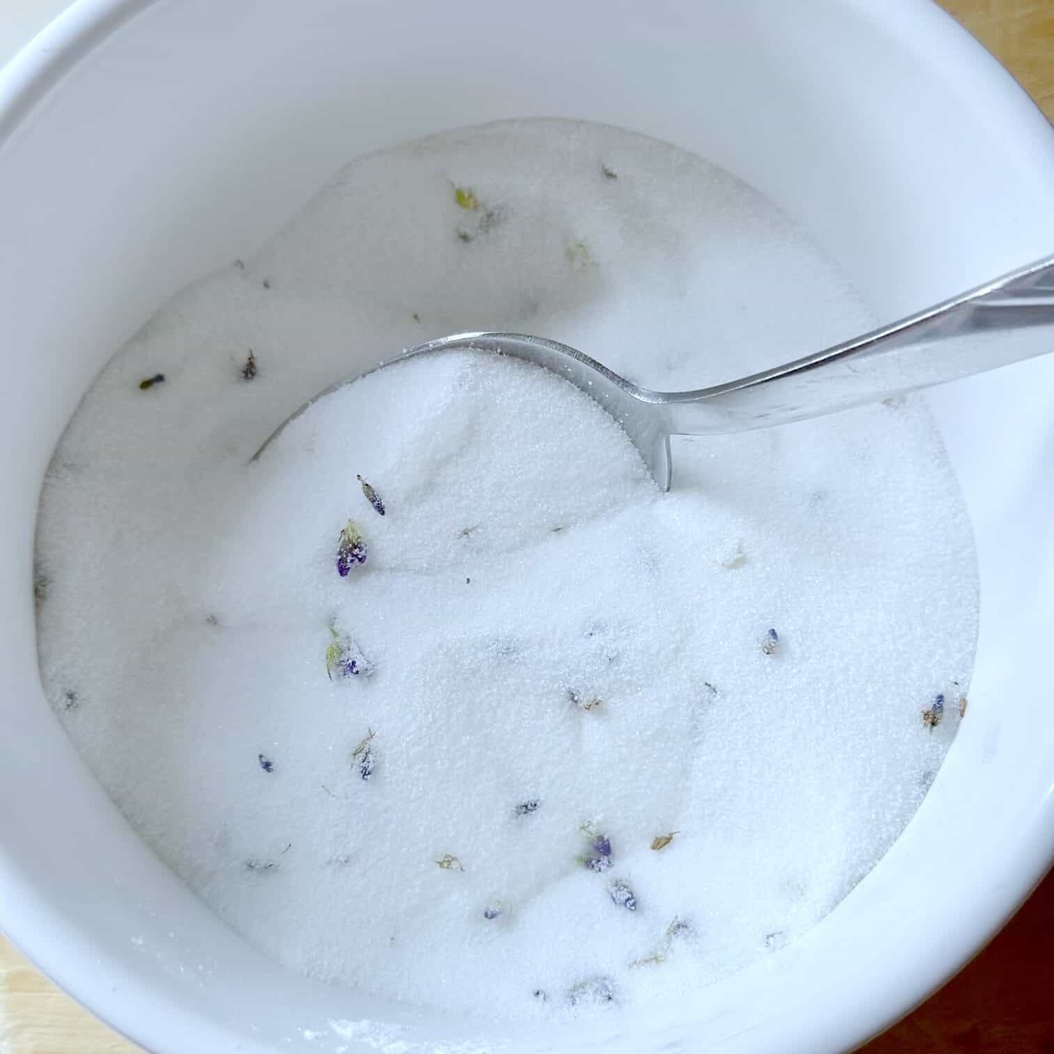 White bowl with a mix of sugar and lavender. 