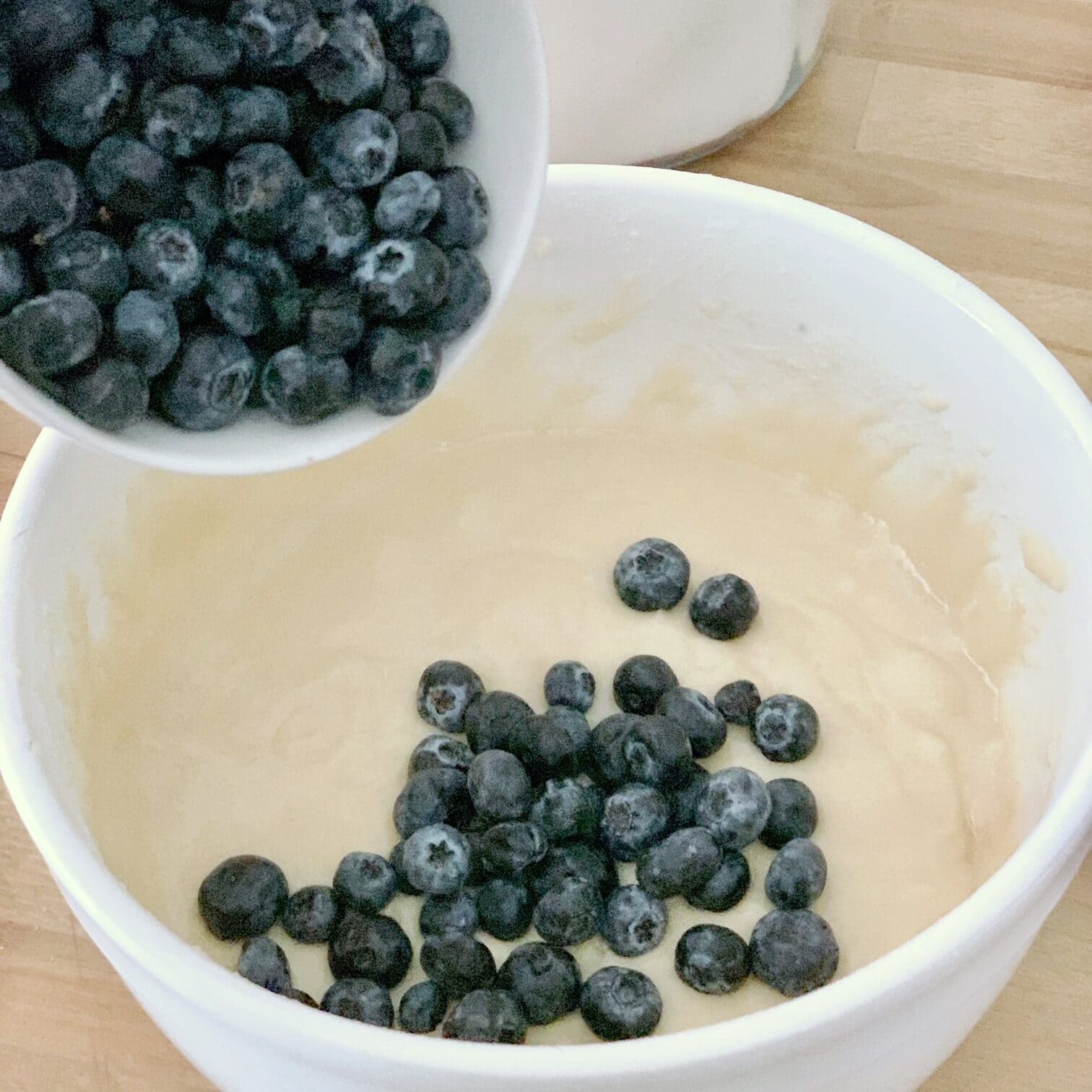Adding fresh blueberries to the batter. 