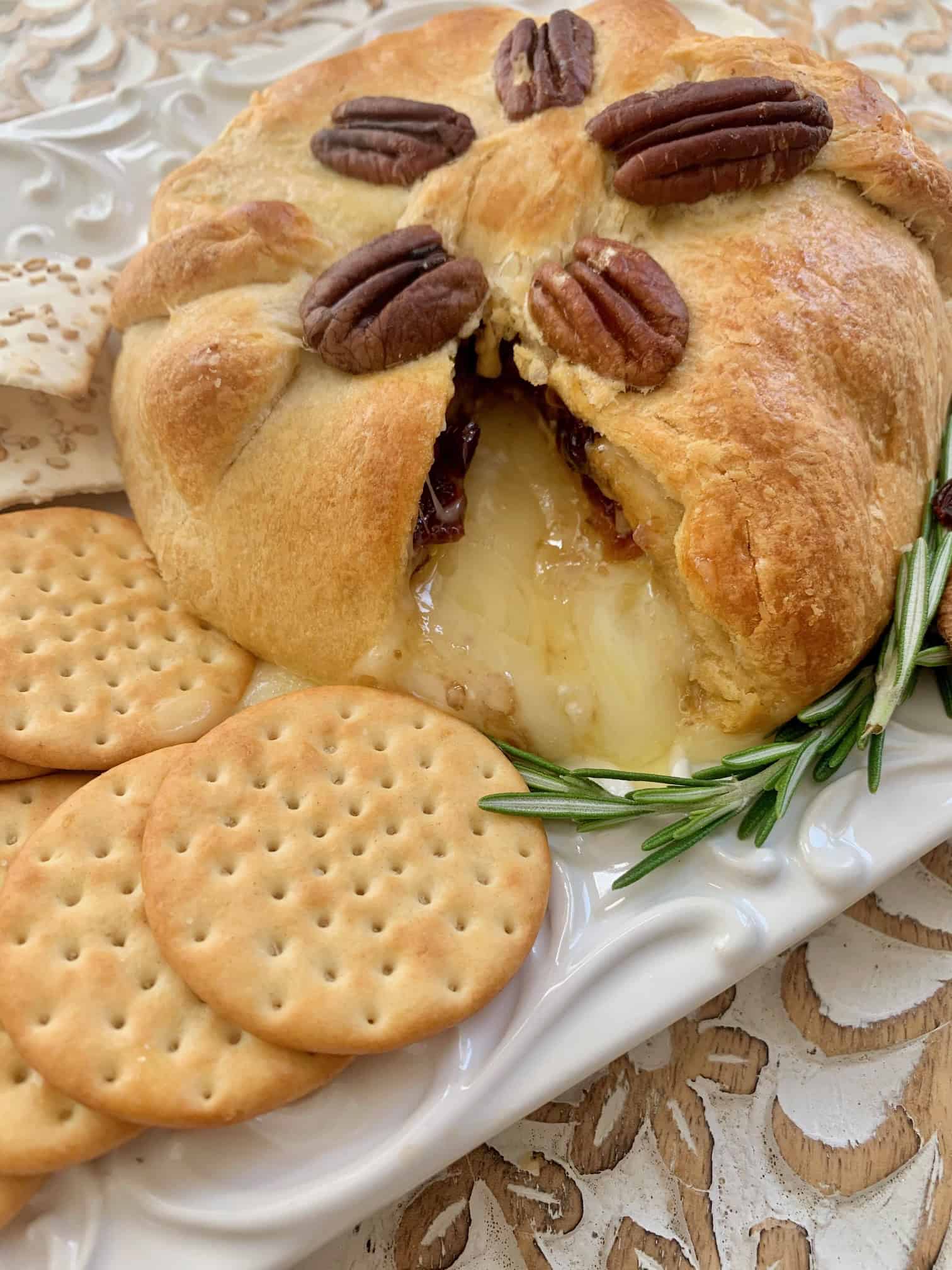 Gooey delicious brie pouring out of the baked dough.