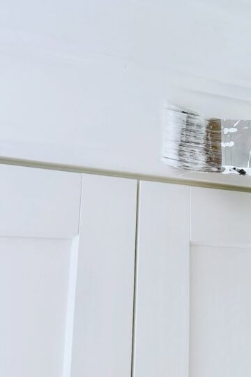 Painting the added trim to our IKEA cabinets White Heron by Benjamin Moore.
