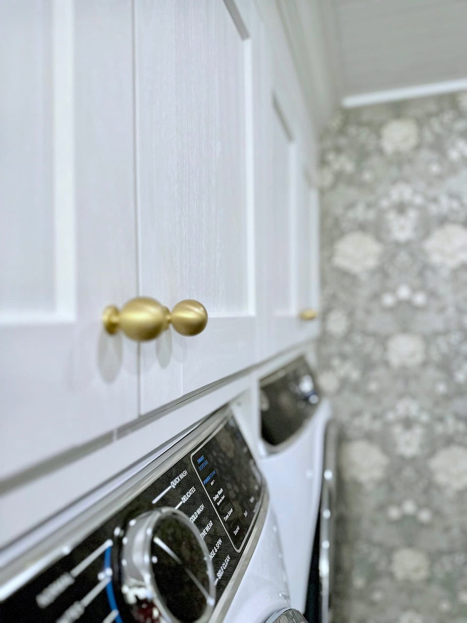A close view of the woodgrain detail on the IKEA ENKÖPING white cabinets.