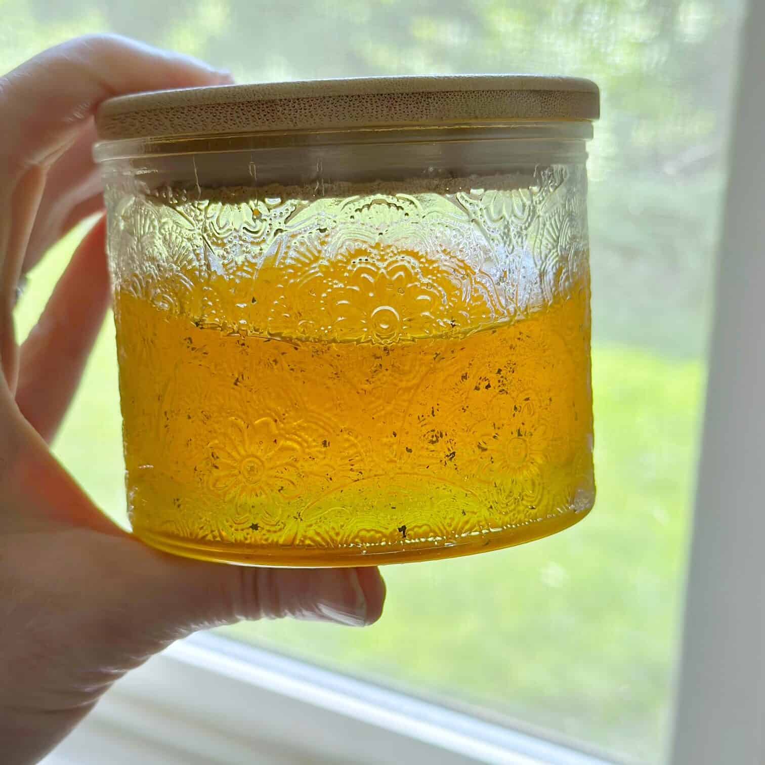 Embossed glass jar with bamboo lid with mint honey. 