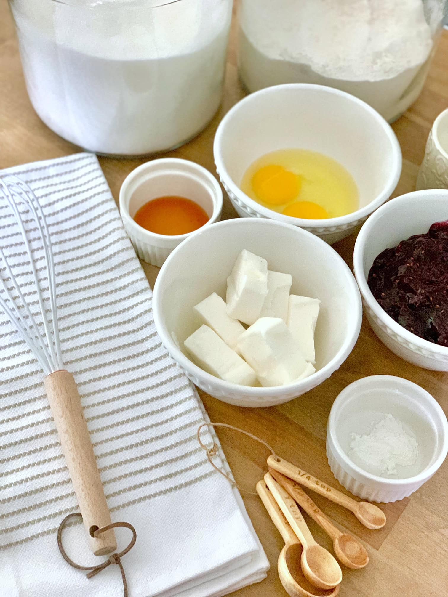 A grouping of ingredients including eggs, shortening, sugar, jelly and vanilla.