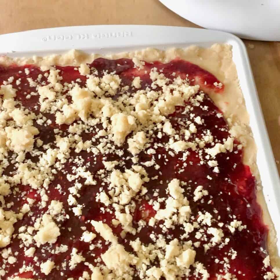 Baked raspberry crumb bars in a pan. 