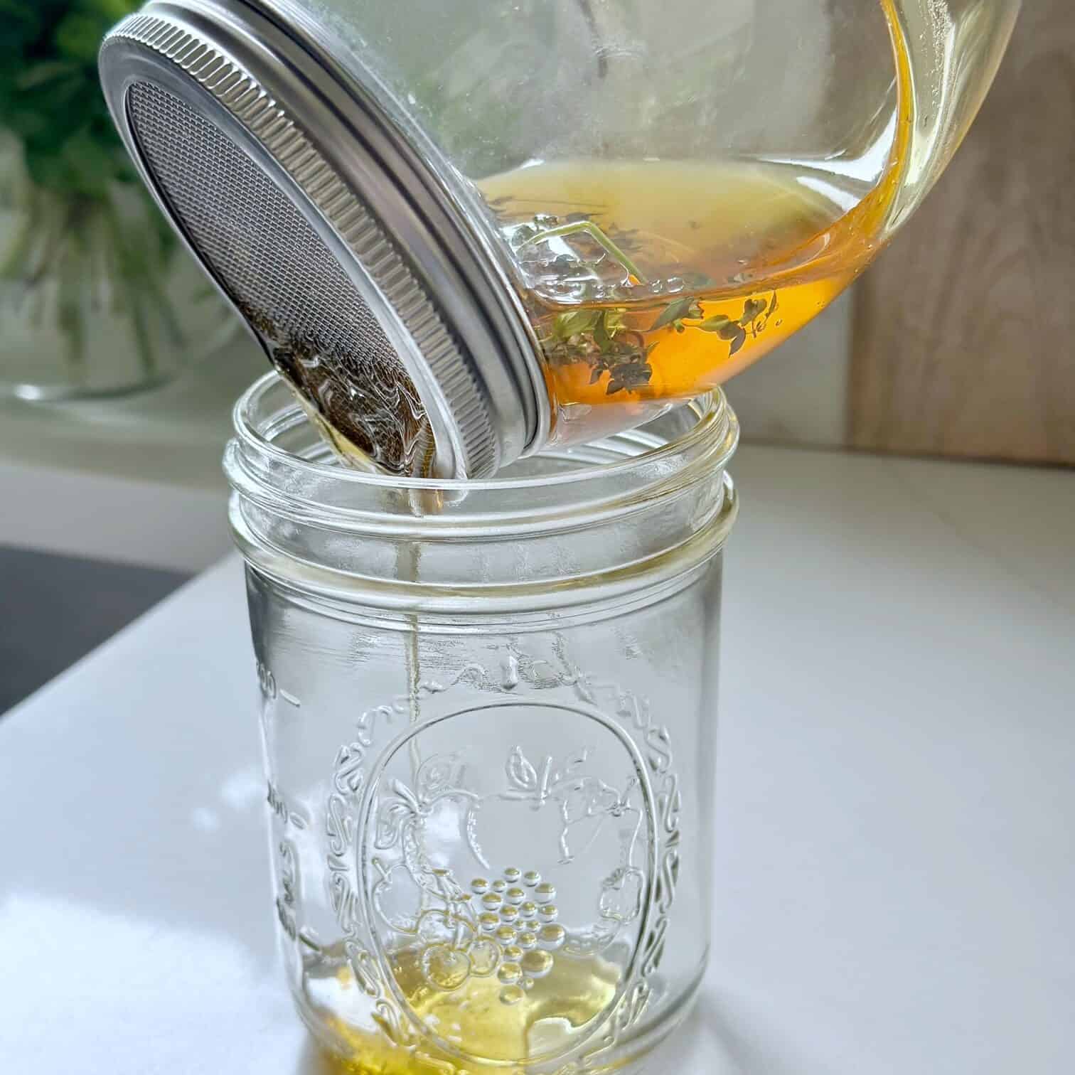 Straining the honey into a jar. 
