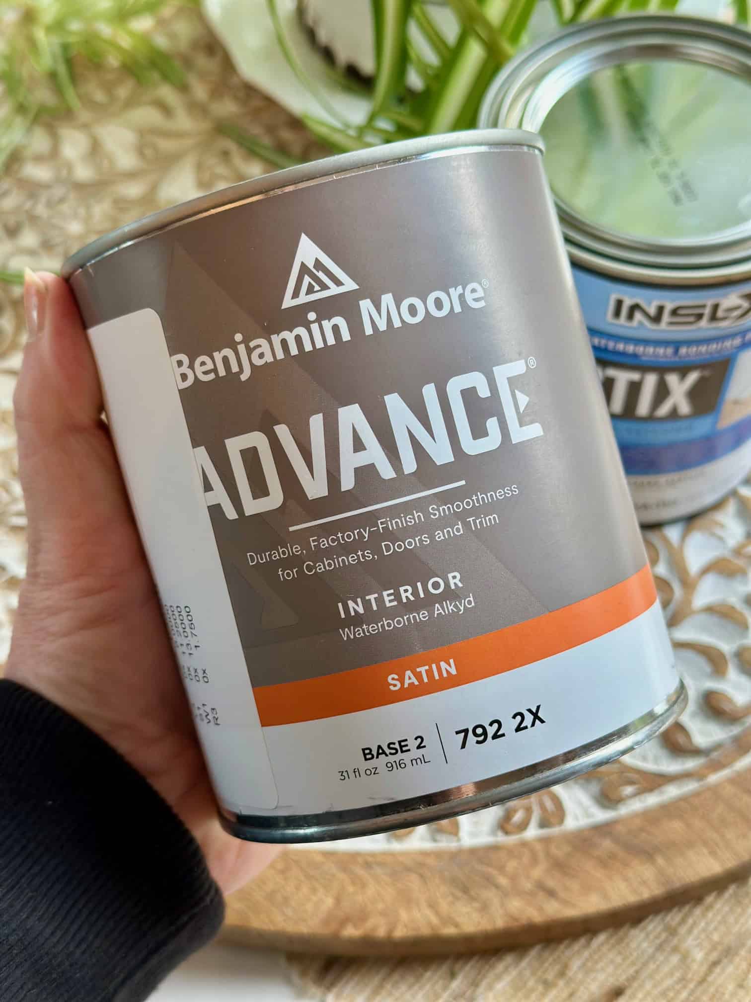 Me holding a can of Benjamin Moore Advance paint. 