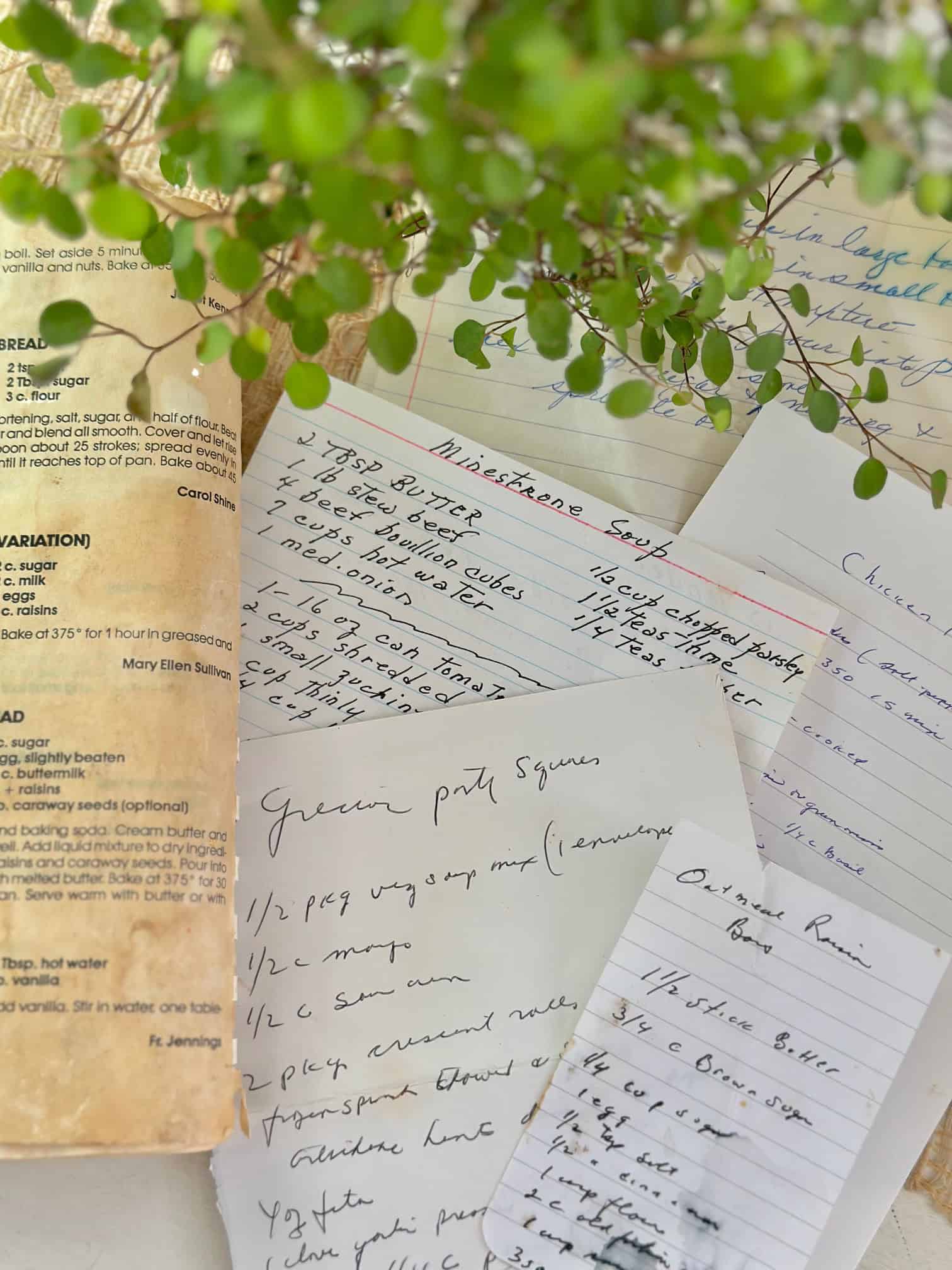 A pile of my mothers recipes and an old cookbook. 