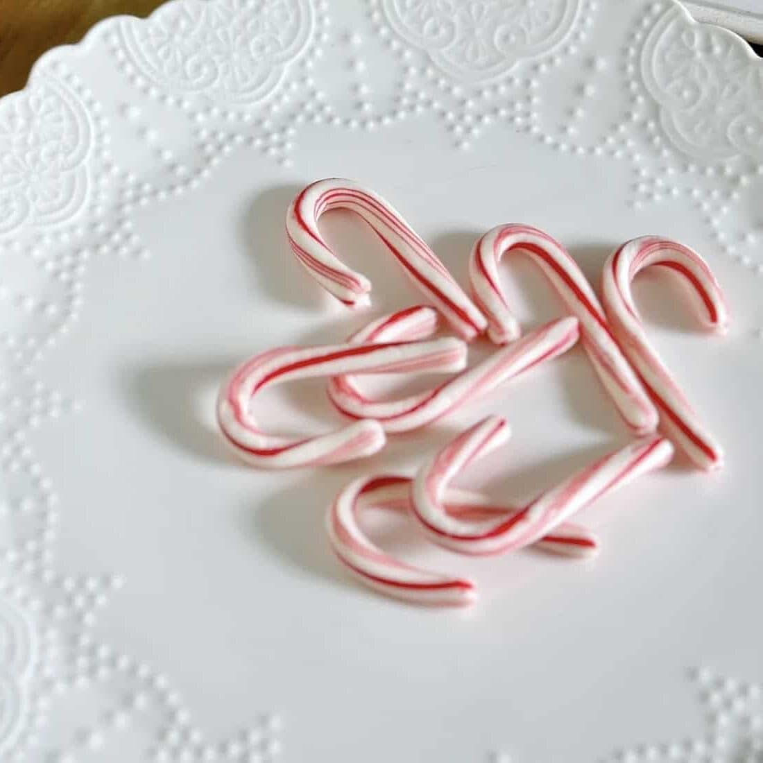 Mini candy canes on a dish.