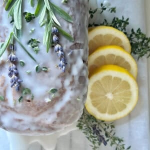 A Beautiful lemon lavender pound cake with fresh thyme. This is the completed loaf with a sprig of fresh lavender on top for garnish.