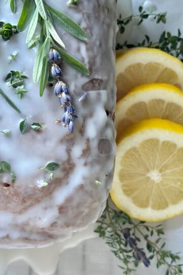 A Beautiful lemon lavender pound cake with fresh thyme. This is the completed loaf with a sprig of fresh lavender on top for garnish.