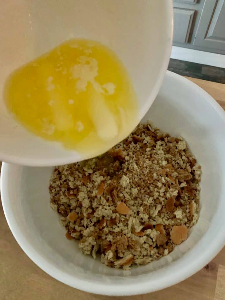 Pouring melted butter into stuffing. 