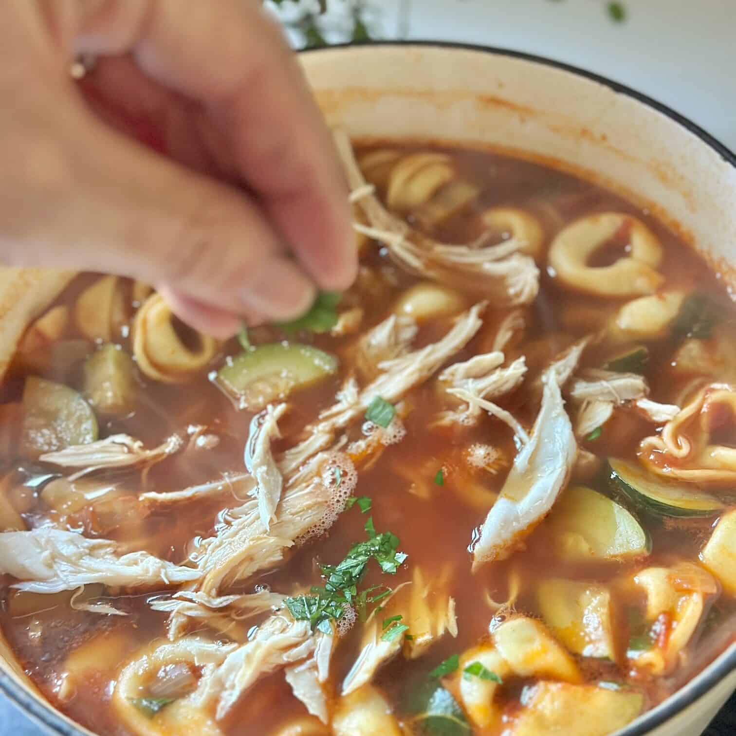 Adding fresh parsley to the soup. 