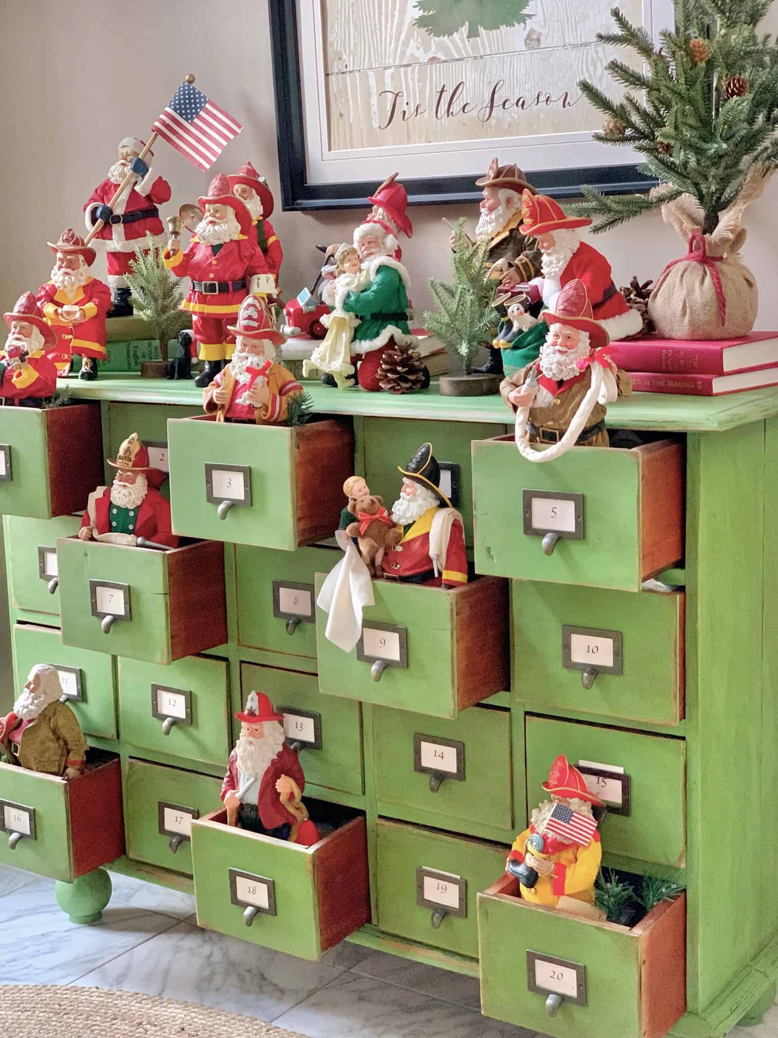 A full view of the Santas on my green apothecary. These Santas greet our guests in our entryway every Christmas. 