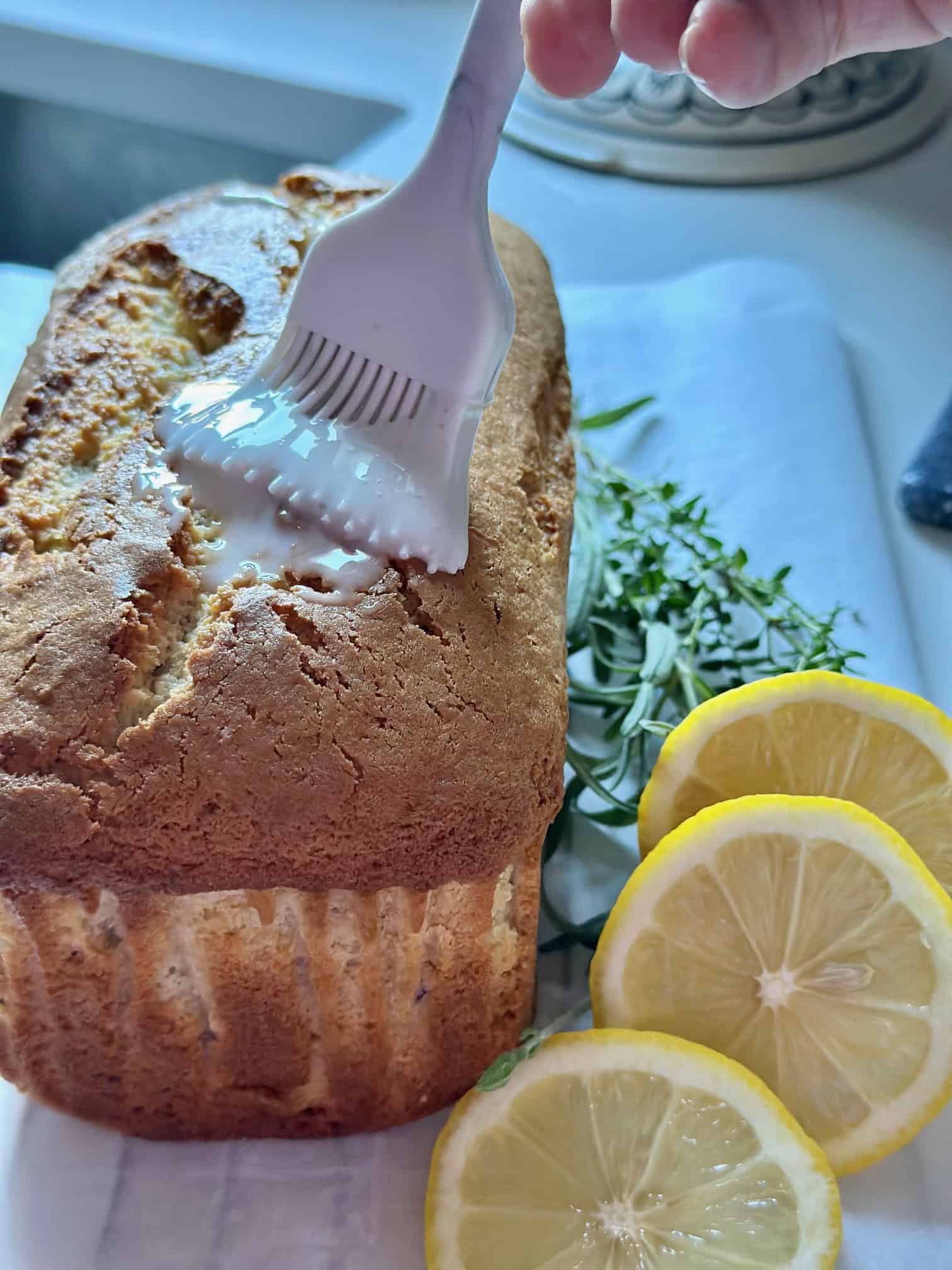 Brushing the glaze over the loaf.