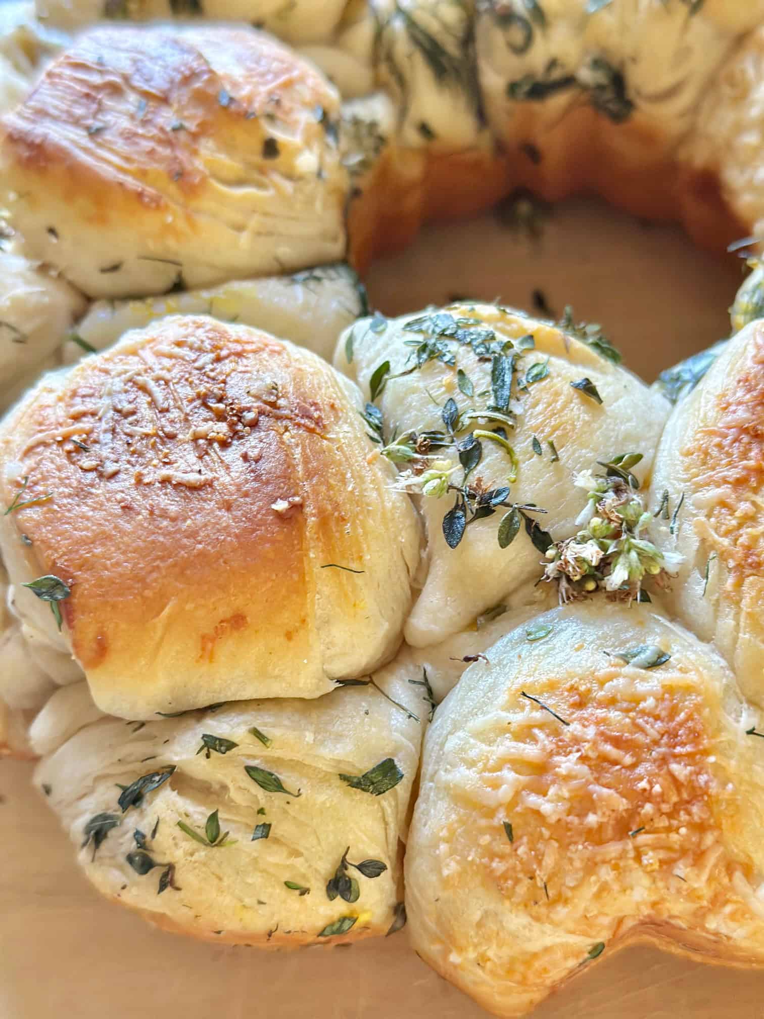 Close view of the freshly baked warn fresh herb pull apart bread.