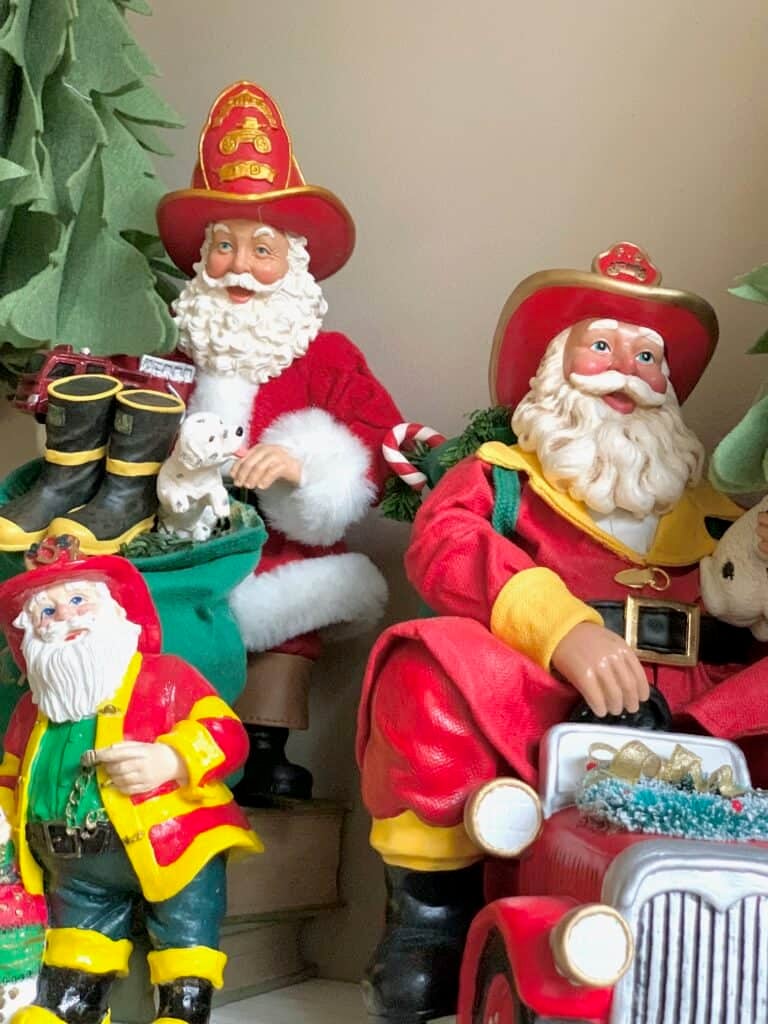 Colorful Firefighter Santa figurines celebrating a firefighter's career.