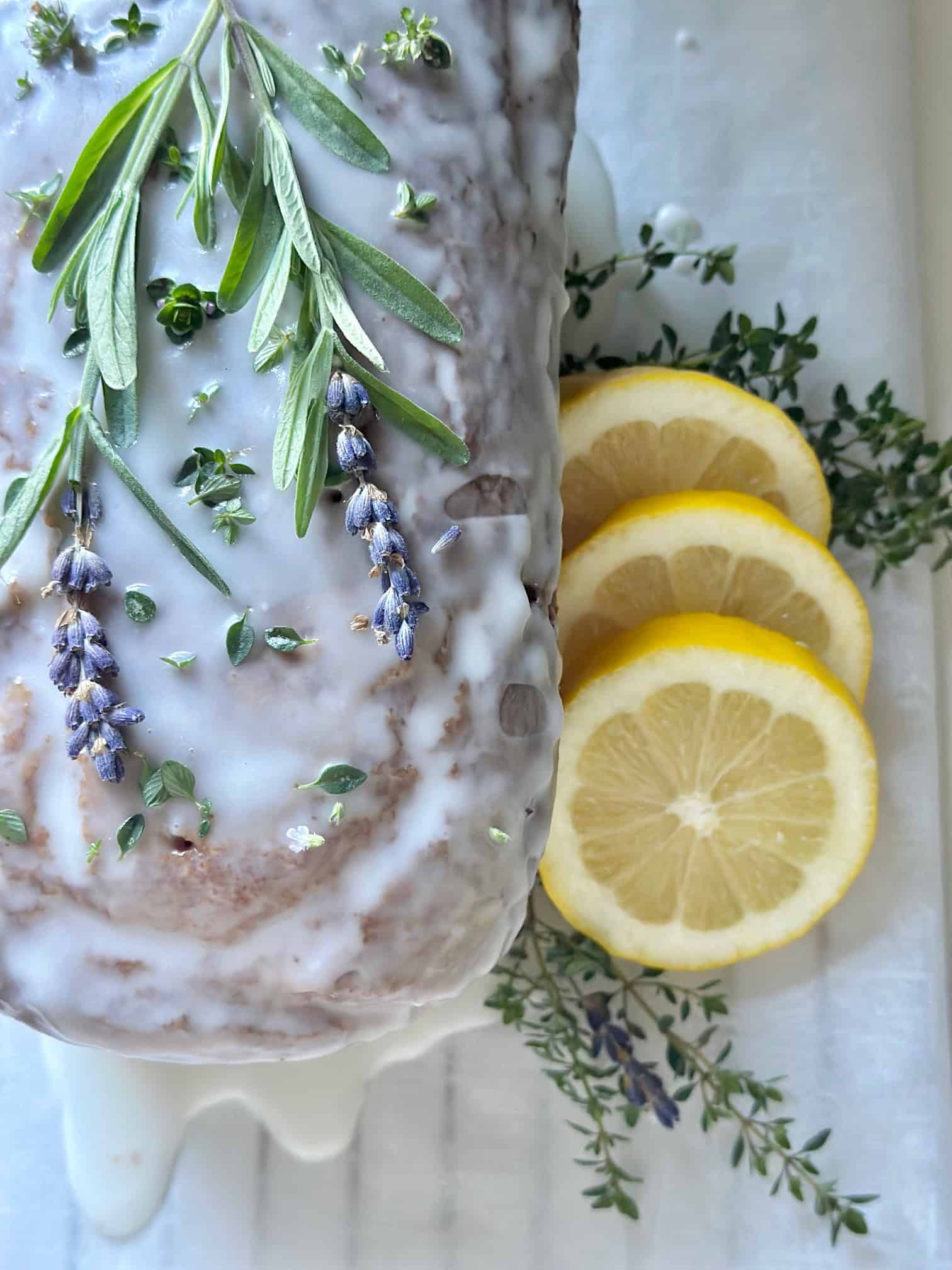 Beautiful lemon lavender pound cake with fresh thyme. This is the completed loaf with a sprig of fresh lavender on top for garnish.
