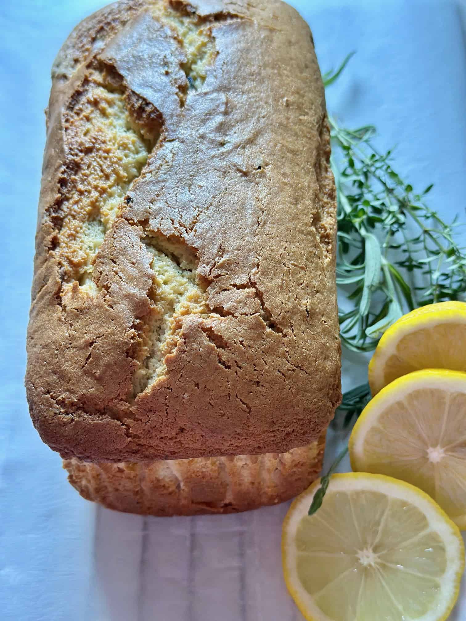 Baked loaf on wire rack with parchment paper.