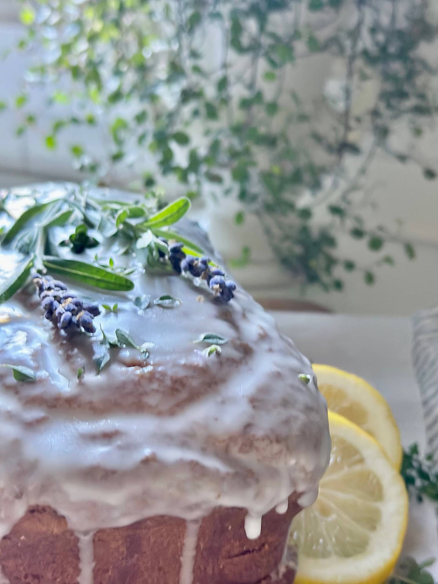Glaze running down the sides of the lemon lavender pound cake.