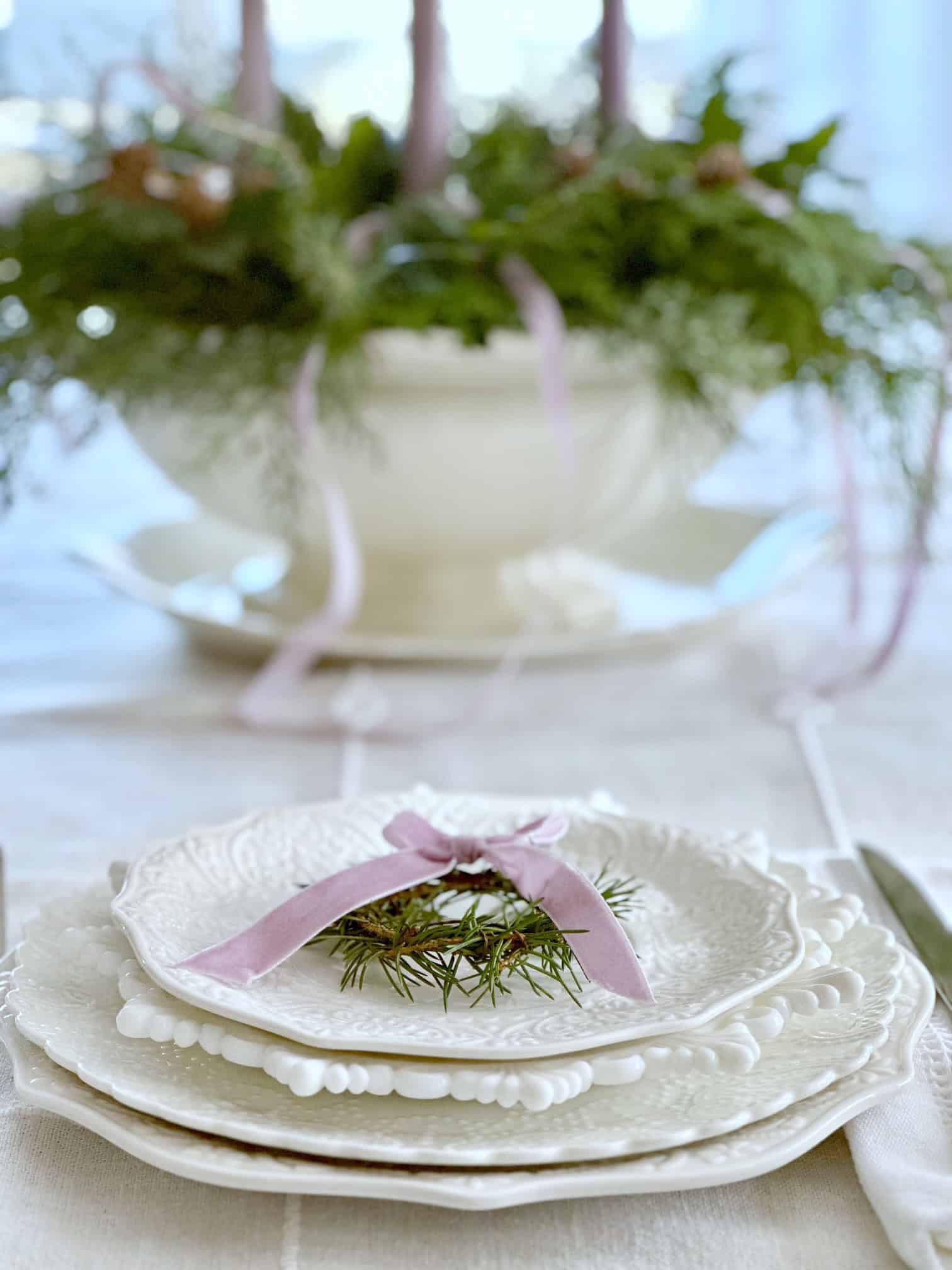 A placesetting in front of the advent wreath centerpiece.