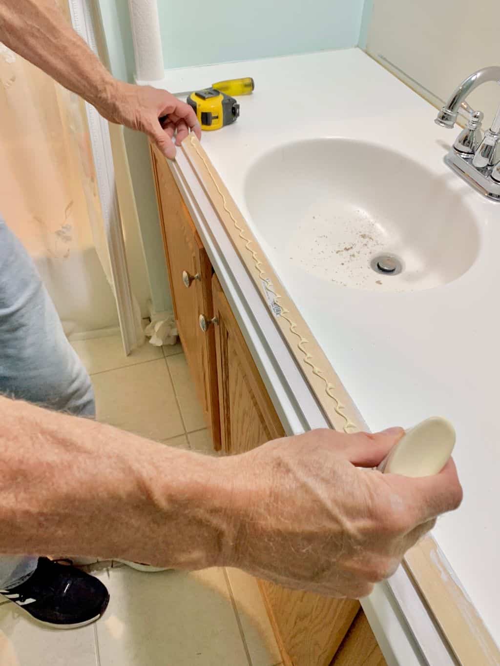 Putting wood glue across the bottom piece.