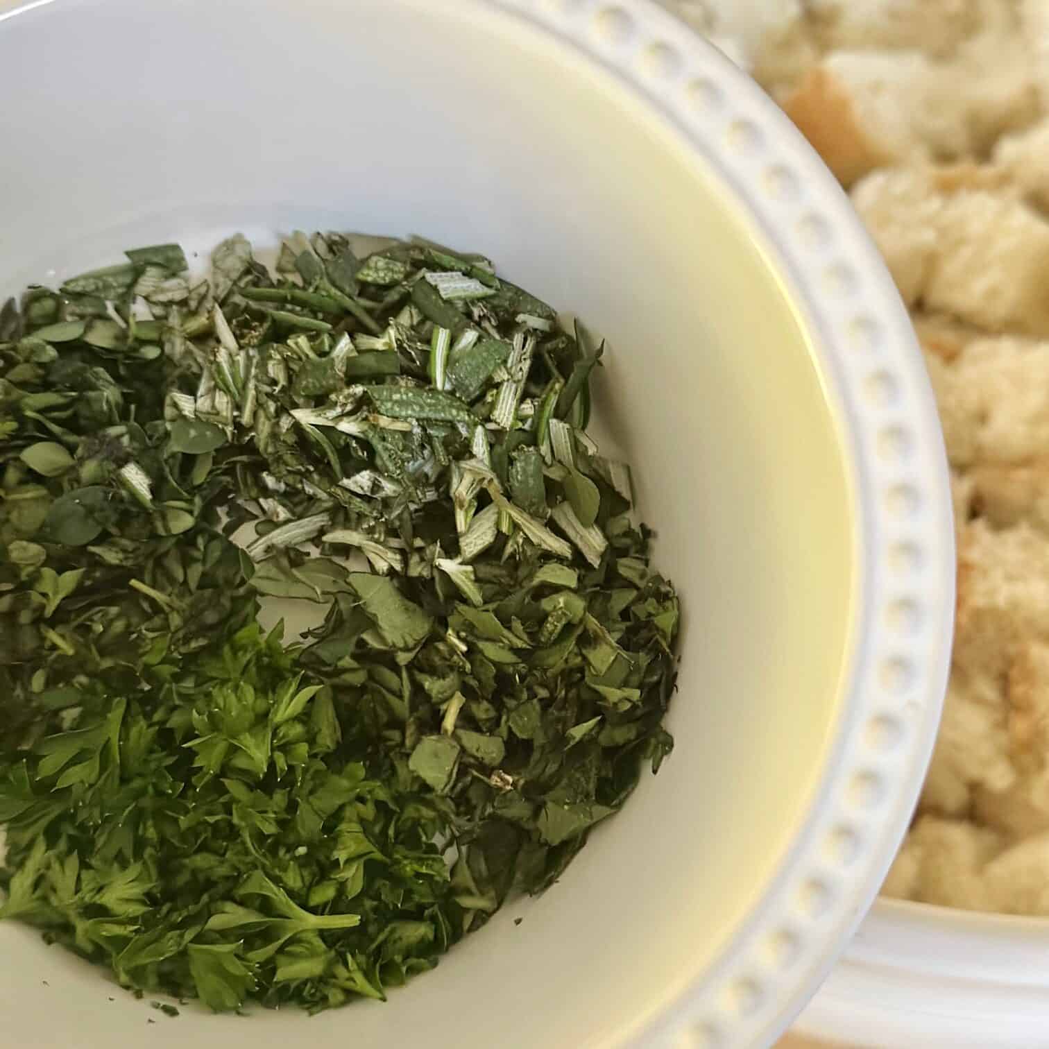 Adding herbs and seasoning to the croutons. 