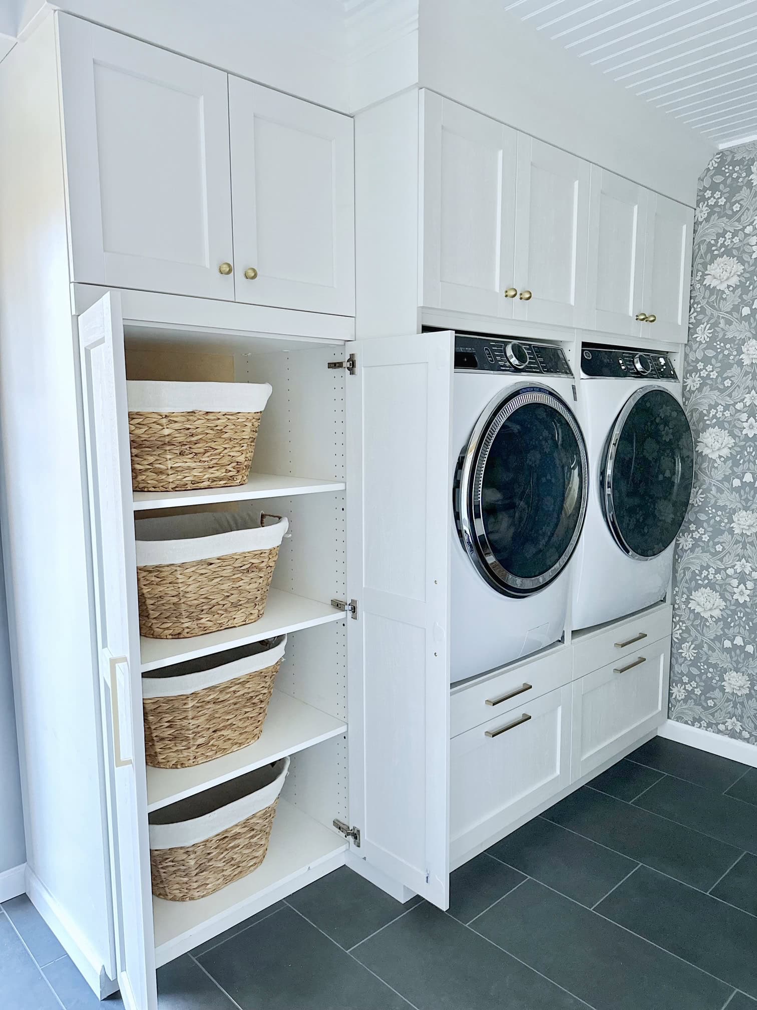 Ikea cabinets that hold our raised washer and dryer. In a tall pantry style cabinet we keep wicker laundry baskets. 