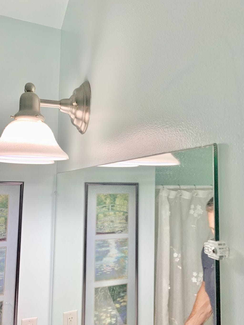 The side view of the builder grade mirror without a frame.