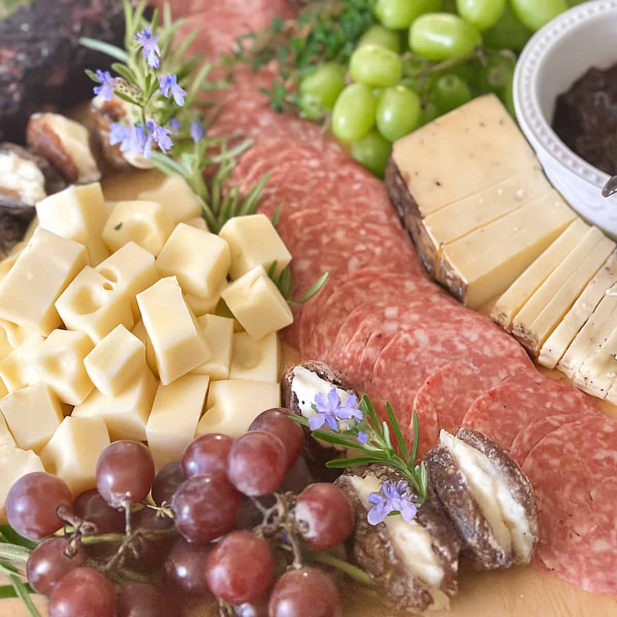 Rosemary flowers on a cheese charcuterie board. 