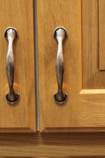Oak cabinets with silver pulls.