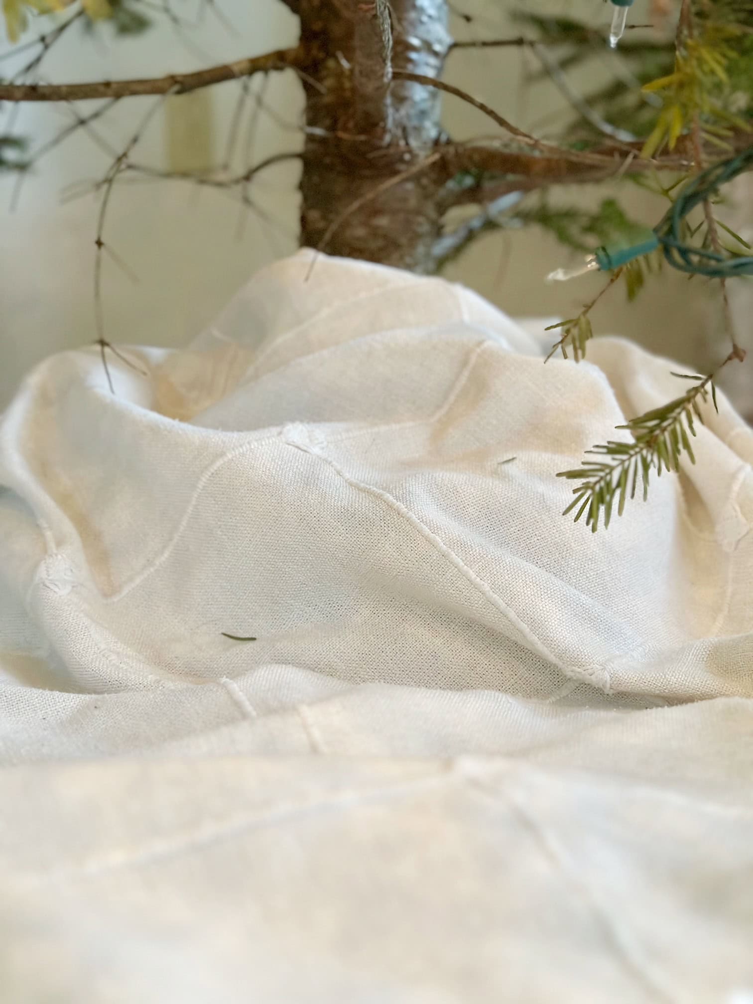 Close view of a table cloth wrapped around a tree trunk. 