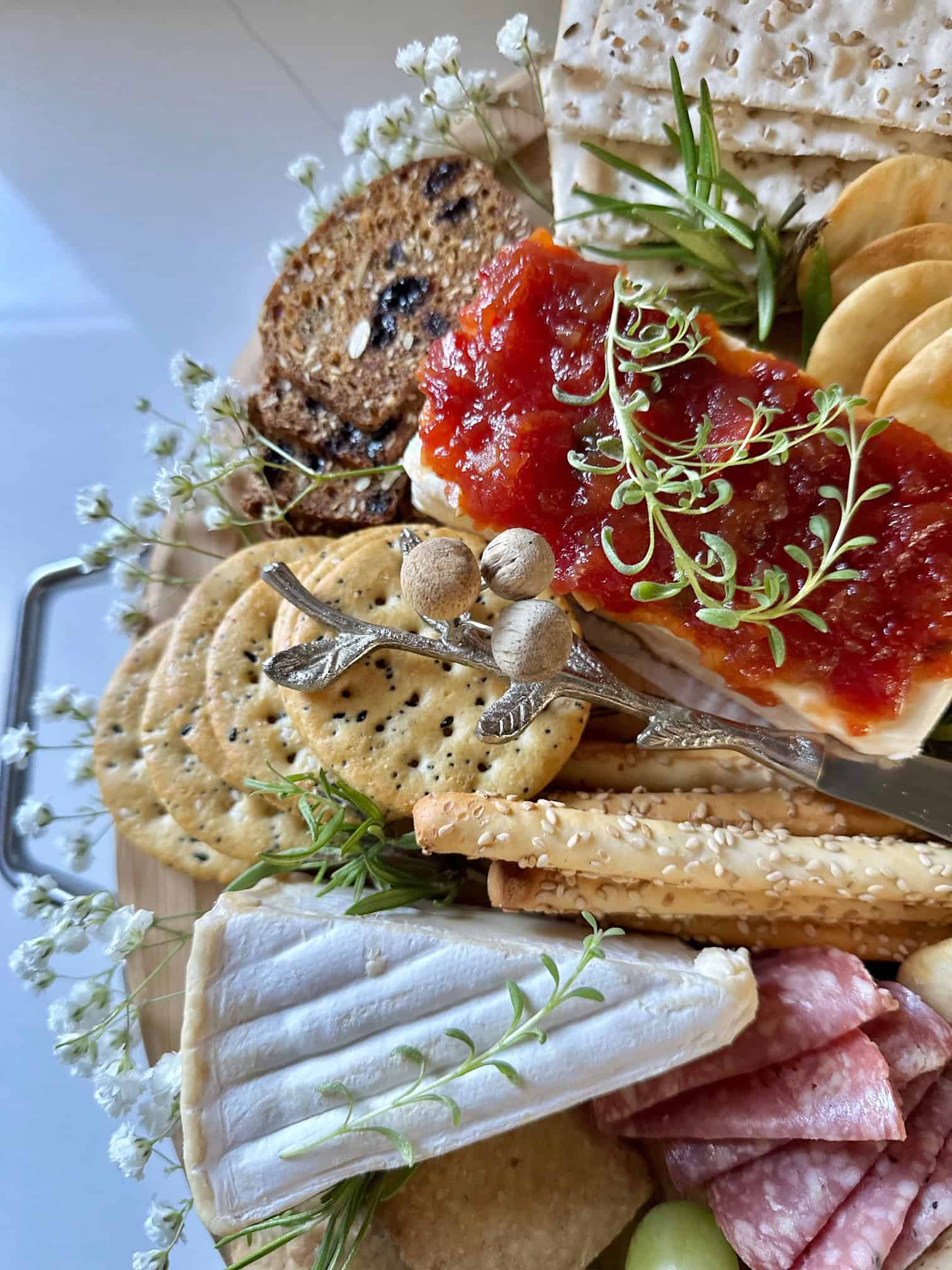 Cream cheese pepper jelly dip on a charcuterie board. 