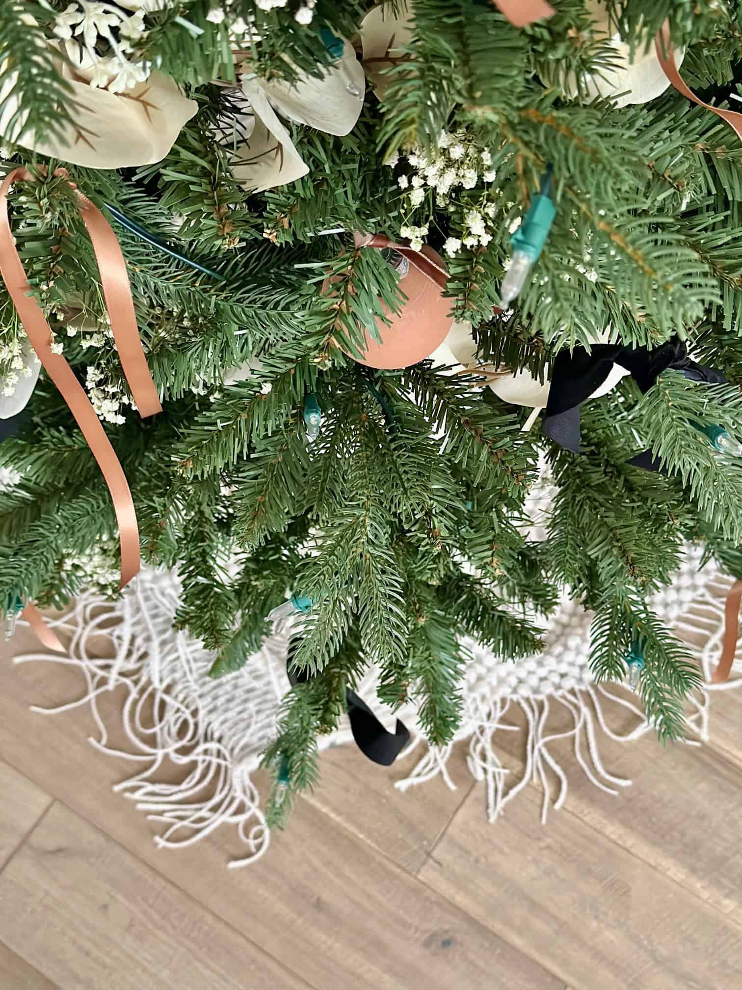 Throw blanket just peaking out below lower branches. 