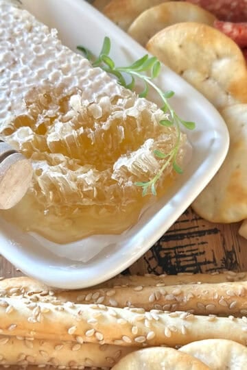 Honeycomb charcuterie board with crackers and cheese.