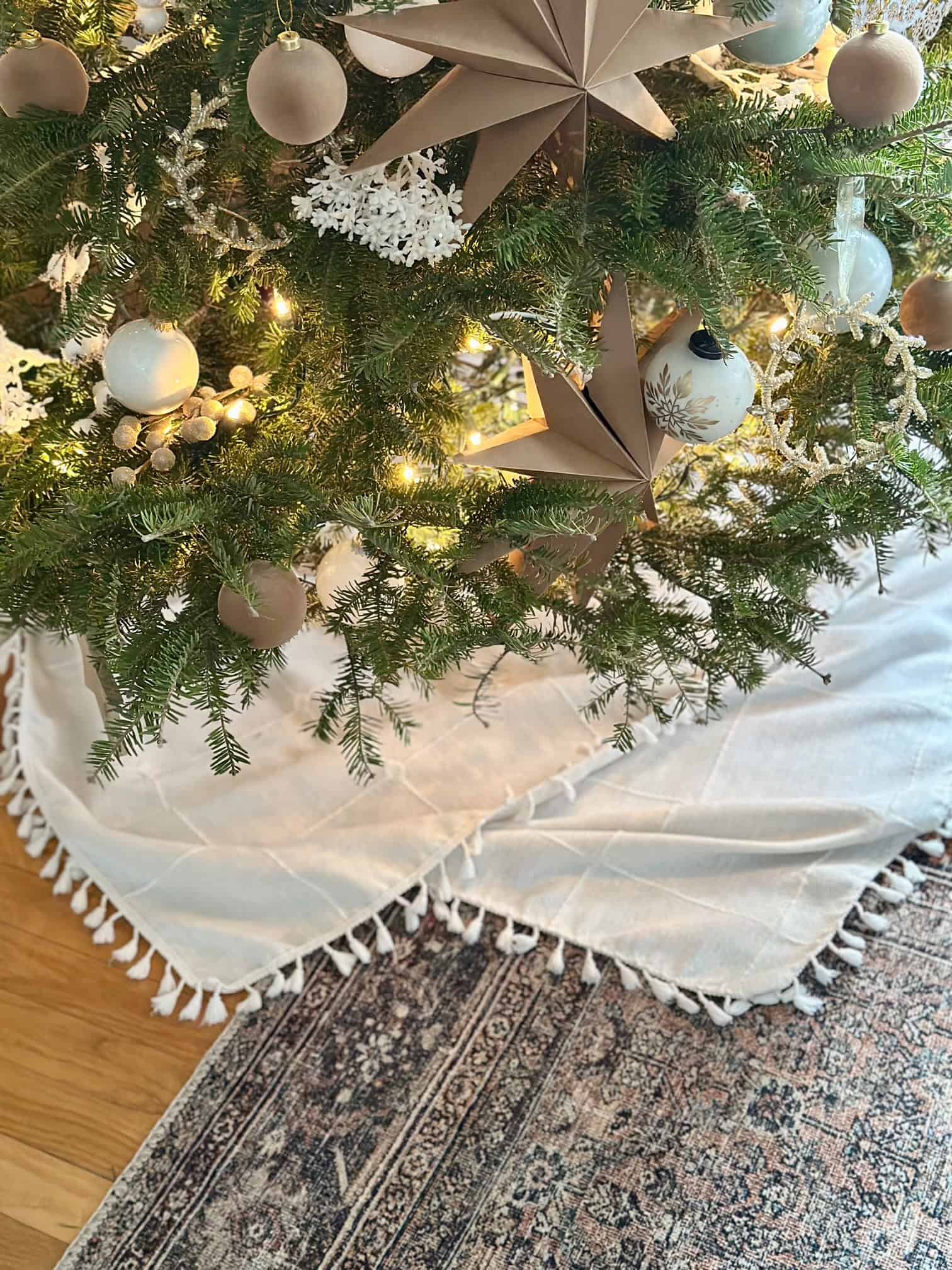 A tablecloth with tassels as a tree skirt alternative. 