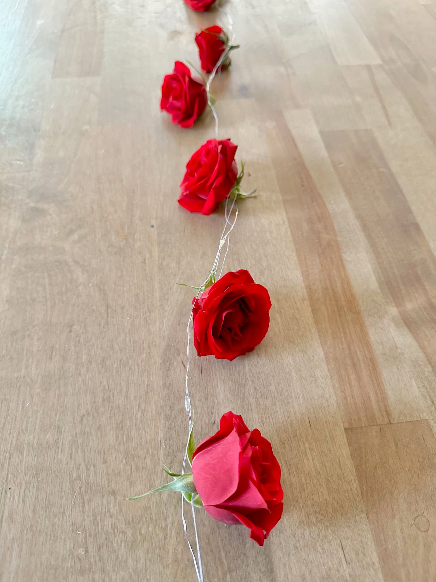 Add the twinkle light wire around the thread.