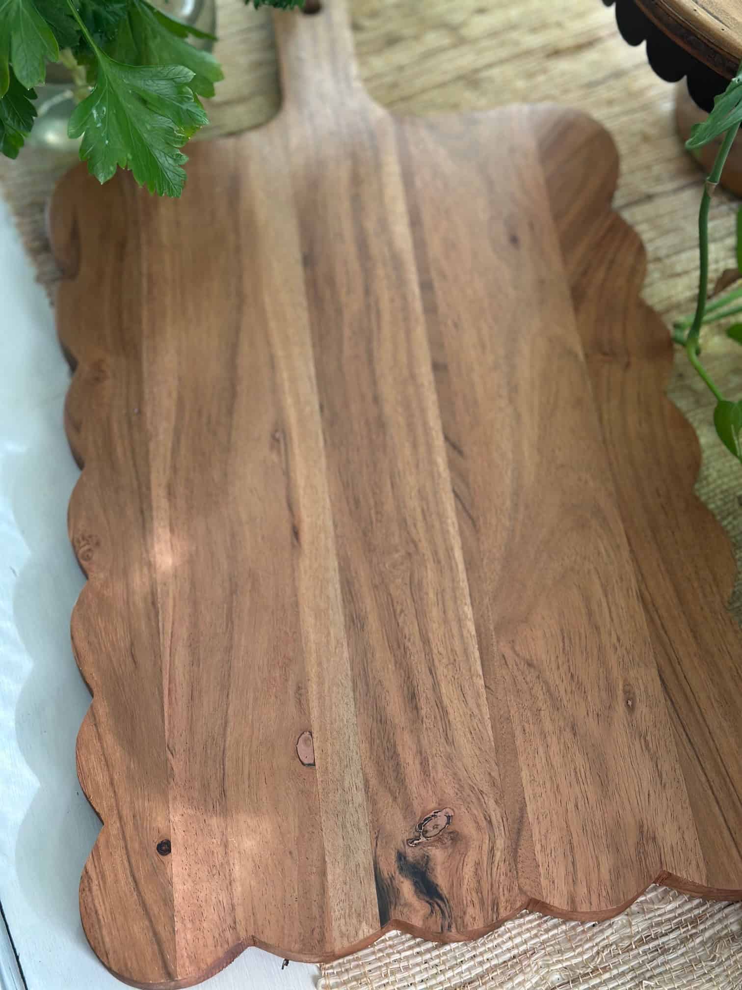 A wooden board with scallop edges. 